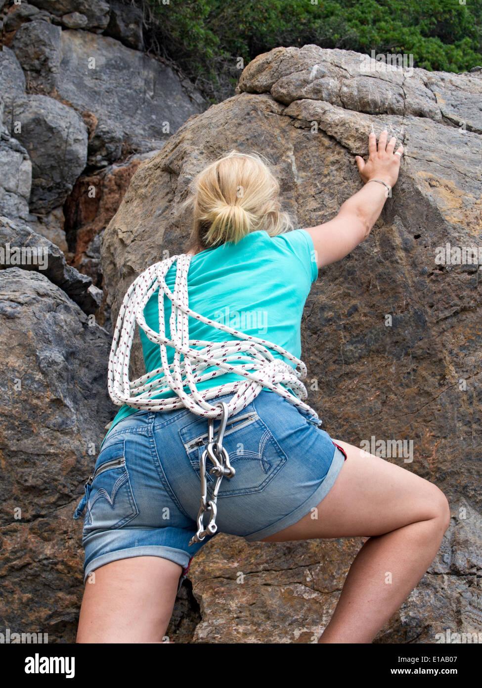 Beautiful young female rock climber Stock Photo