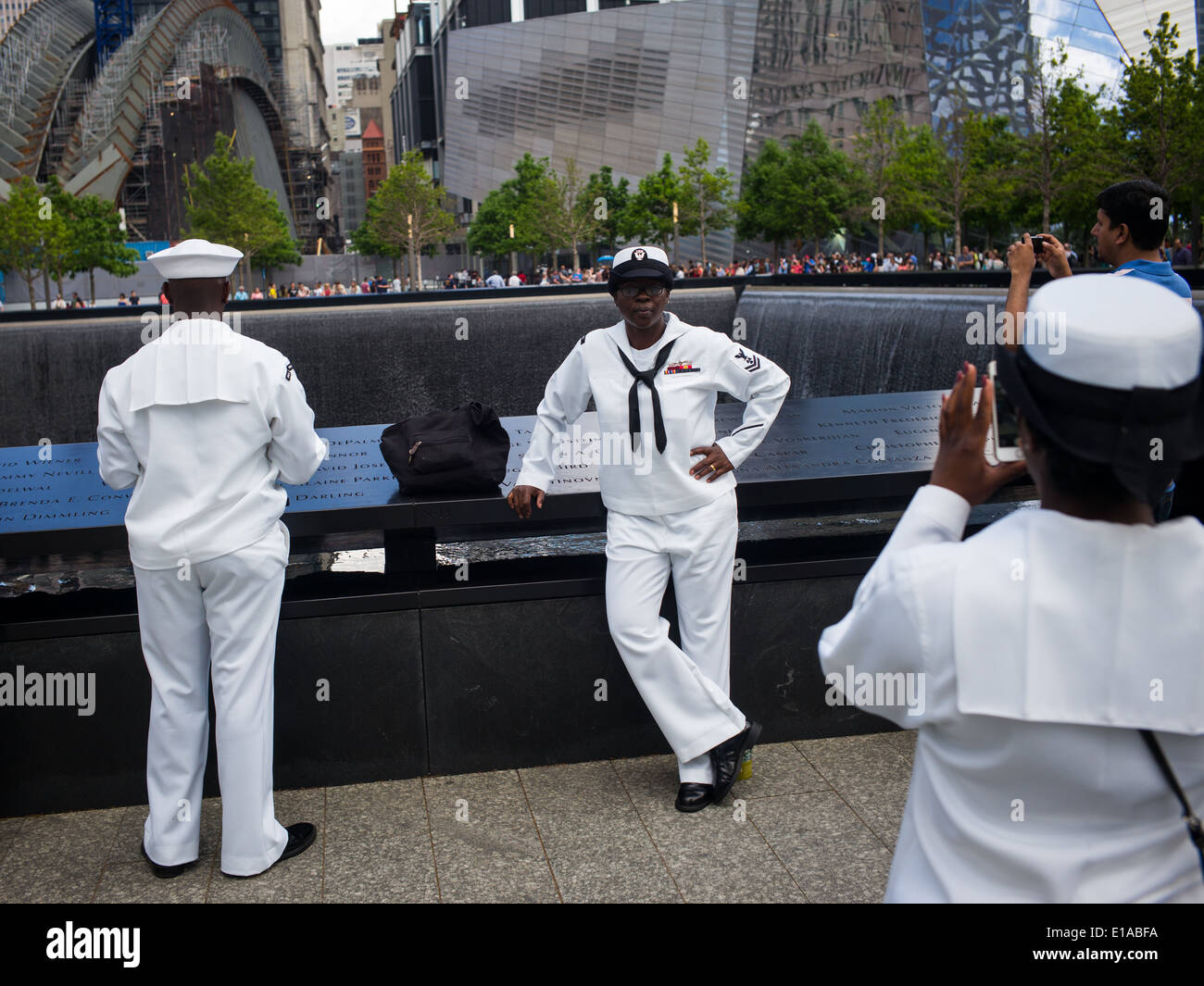 US Navy sailors from the USS Oak Hill take pictures taken in the ground zero area of the 9-11 memorial in lower Manhattan, NYC. Stock Photo
