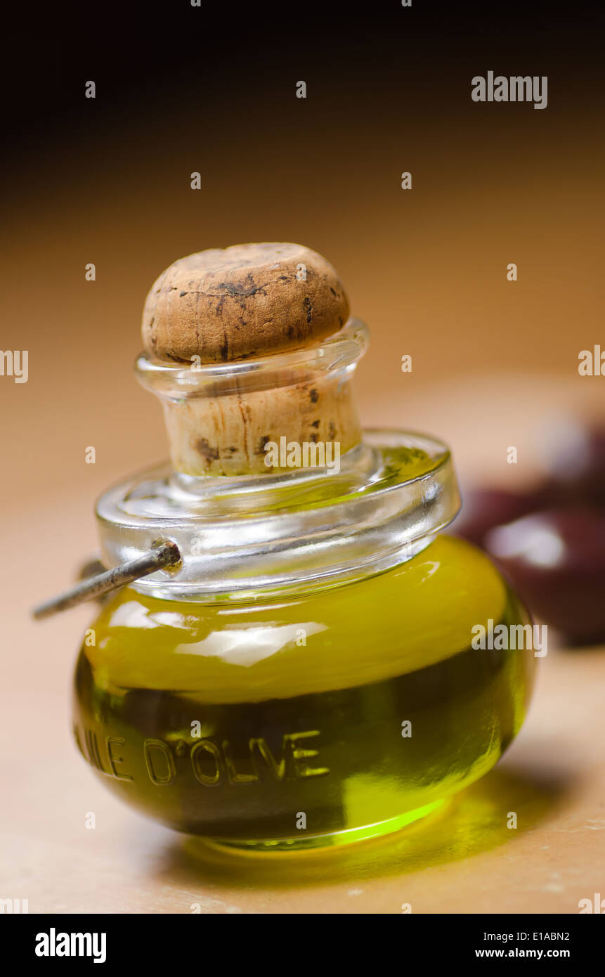 A bottle of extra virgin olive oil with olives. Stock Photo