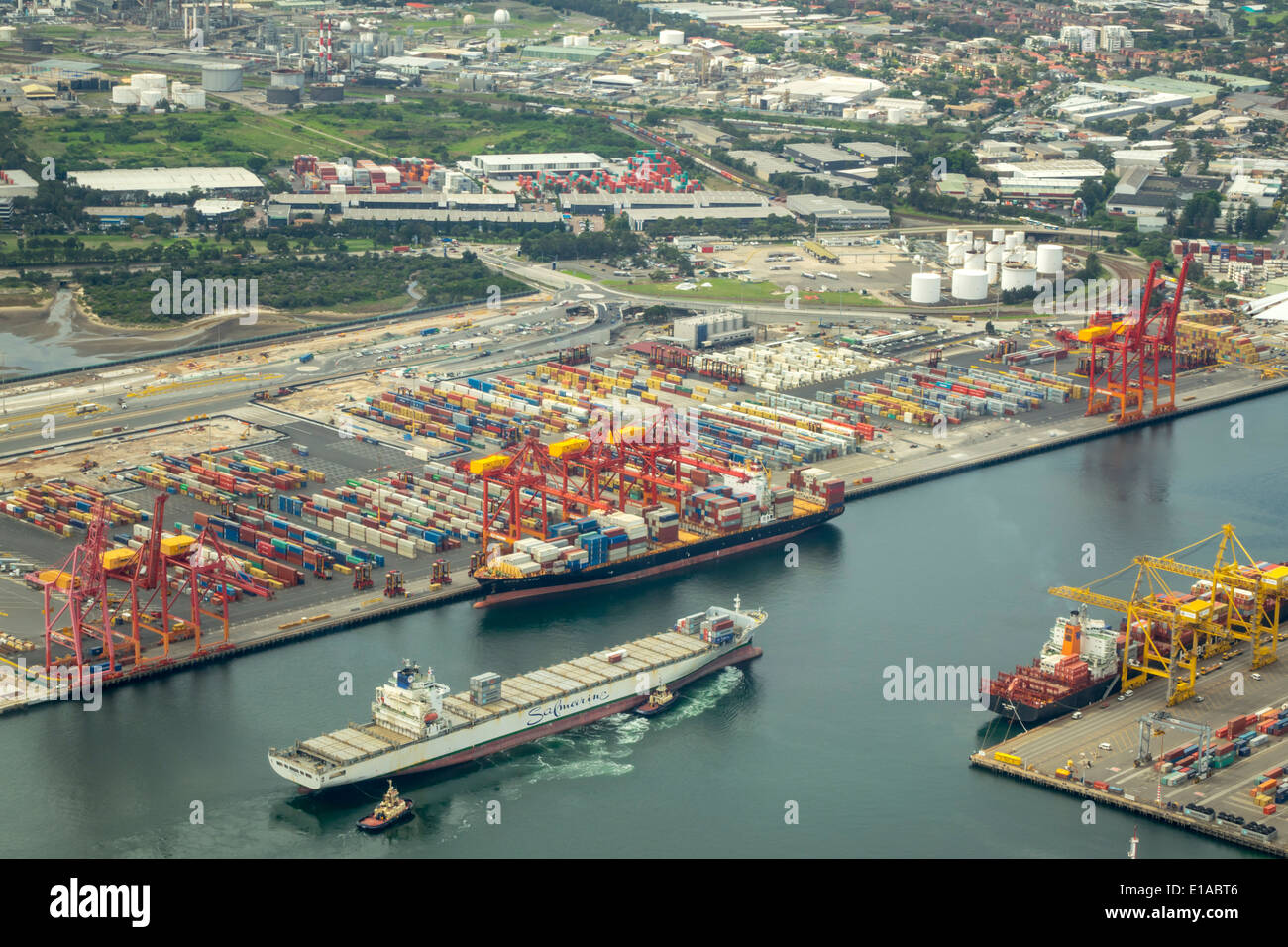 Sydney Australia,Banksmeadow,Port of Botany Bay,shipping,lifting cranes,cargo container ship,aerial overhead view from above,tugboat,AU140312072 Stock Photo