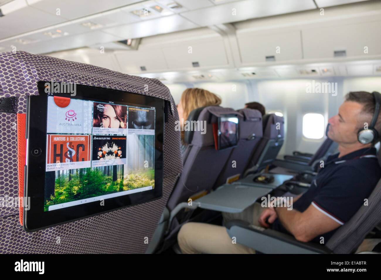 Sydney Australia,Kingsford-Smith Airport,SYD,Qantas Airlines,onboard,Brisbane flight,provided,iPad,tablet,passenger passengers rider riders,seats,in-f Stock Photo