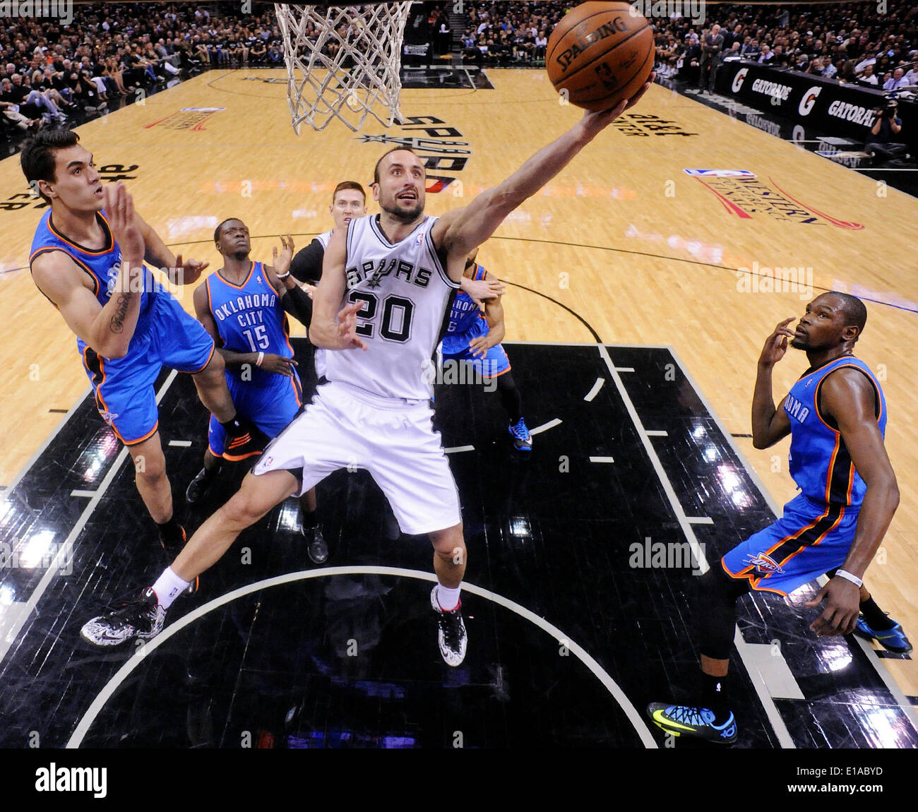 May 19, 2014 - San Antonio, TEXAS, USA - San Antonio Spurs' Manu Ginobili shoots between Oklahoma City Thunder's Steven Adams (left) and Kevin Durant during second half action of Game 1 in the Western Conference Finals Monday May 19, 2014 at the AT&T Center. The Spurs won 122-105. (Credit Image: © San Antonio Express-News/ZUMAPRESS.com) Stock Photo