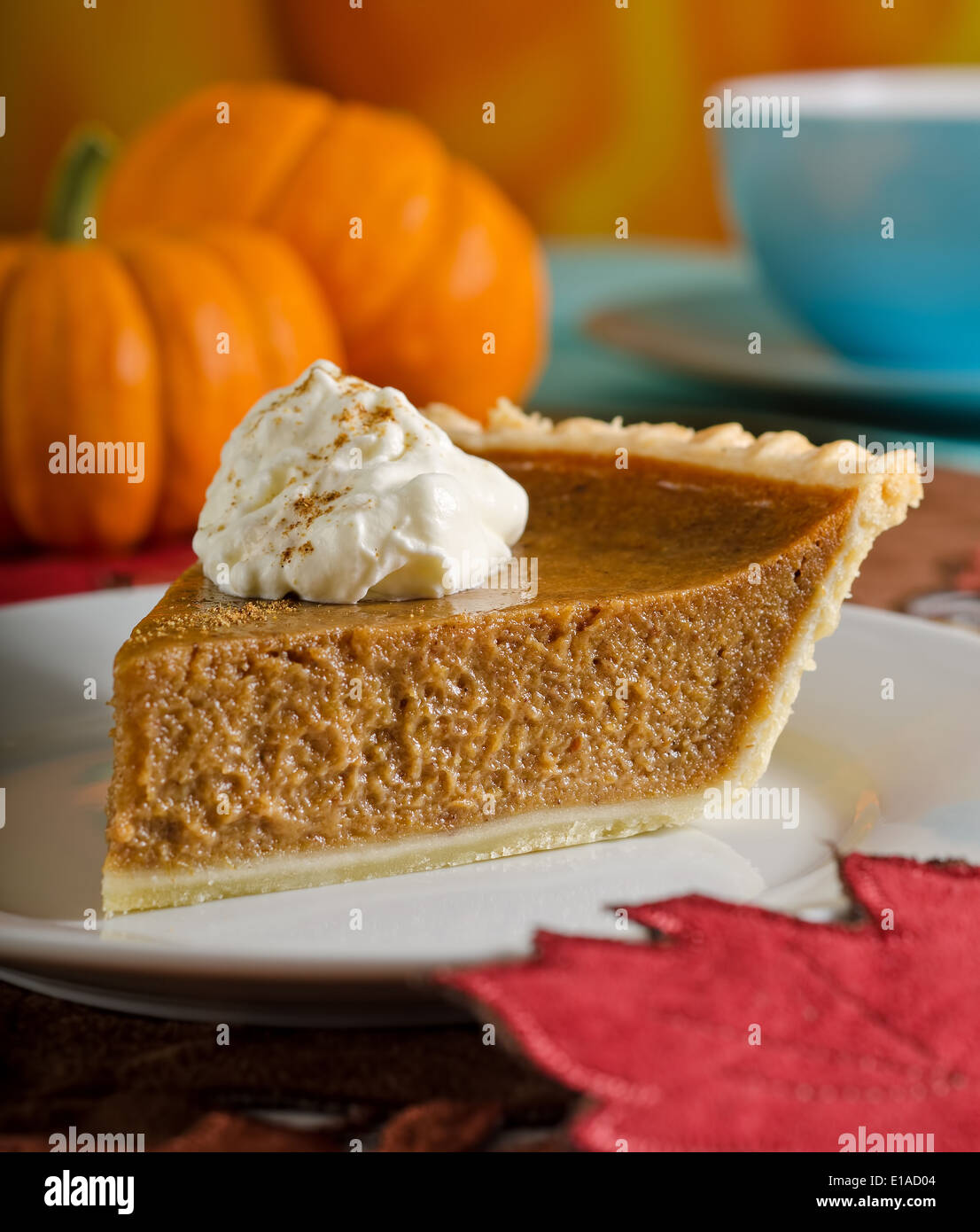 A delicious slice of fresh pumpkin pie with whipped cream. Stock Photo