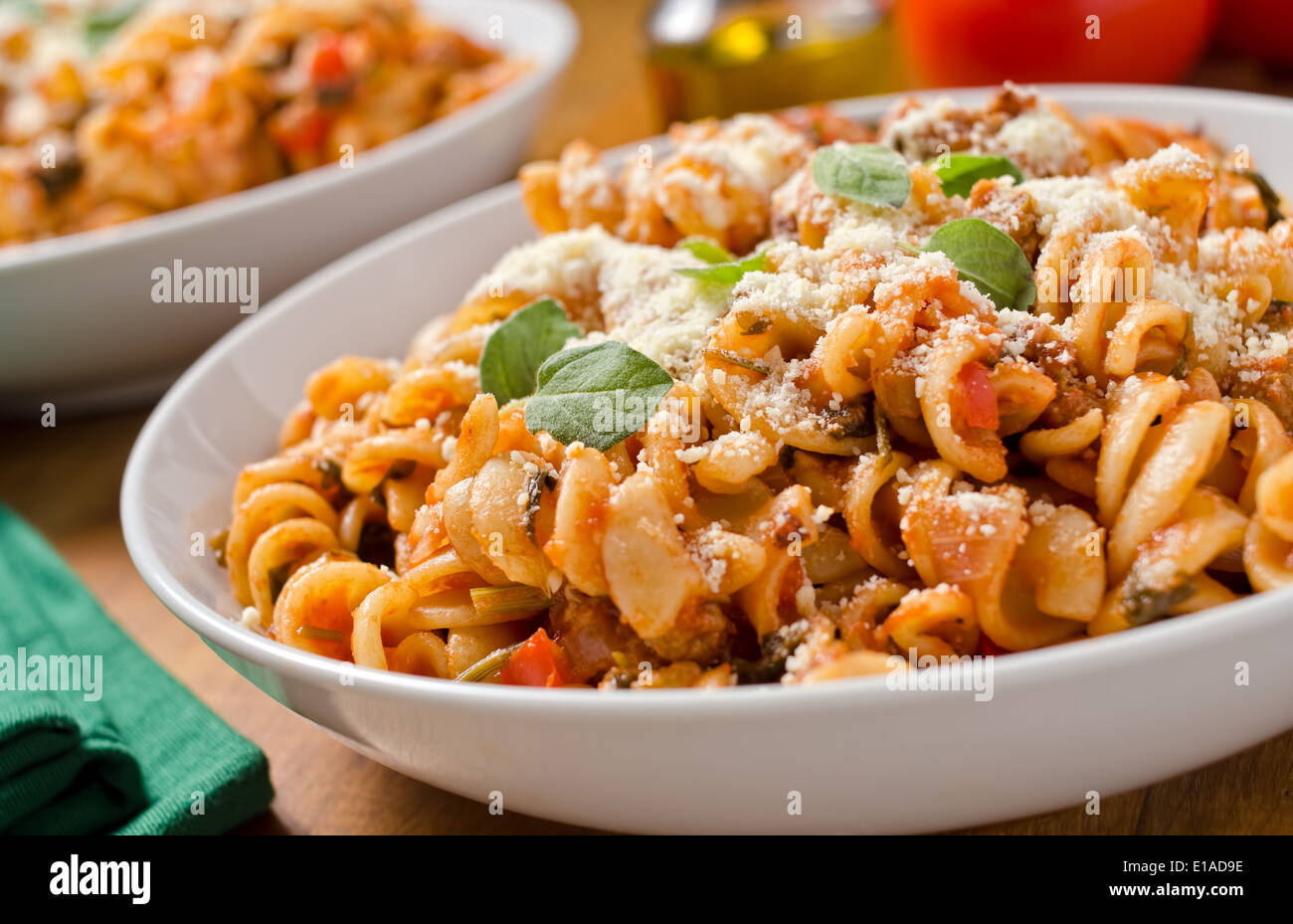 Rotini pasta with marinara sauce, parmesan cheese, and fresh basil. Stock Photo