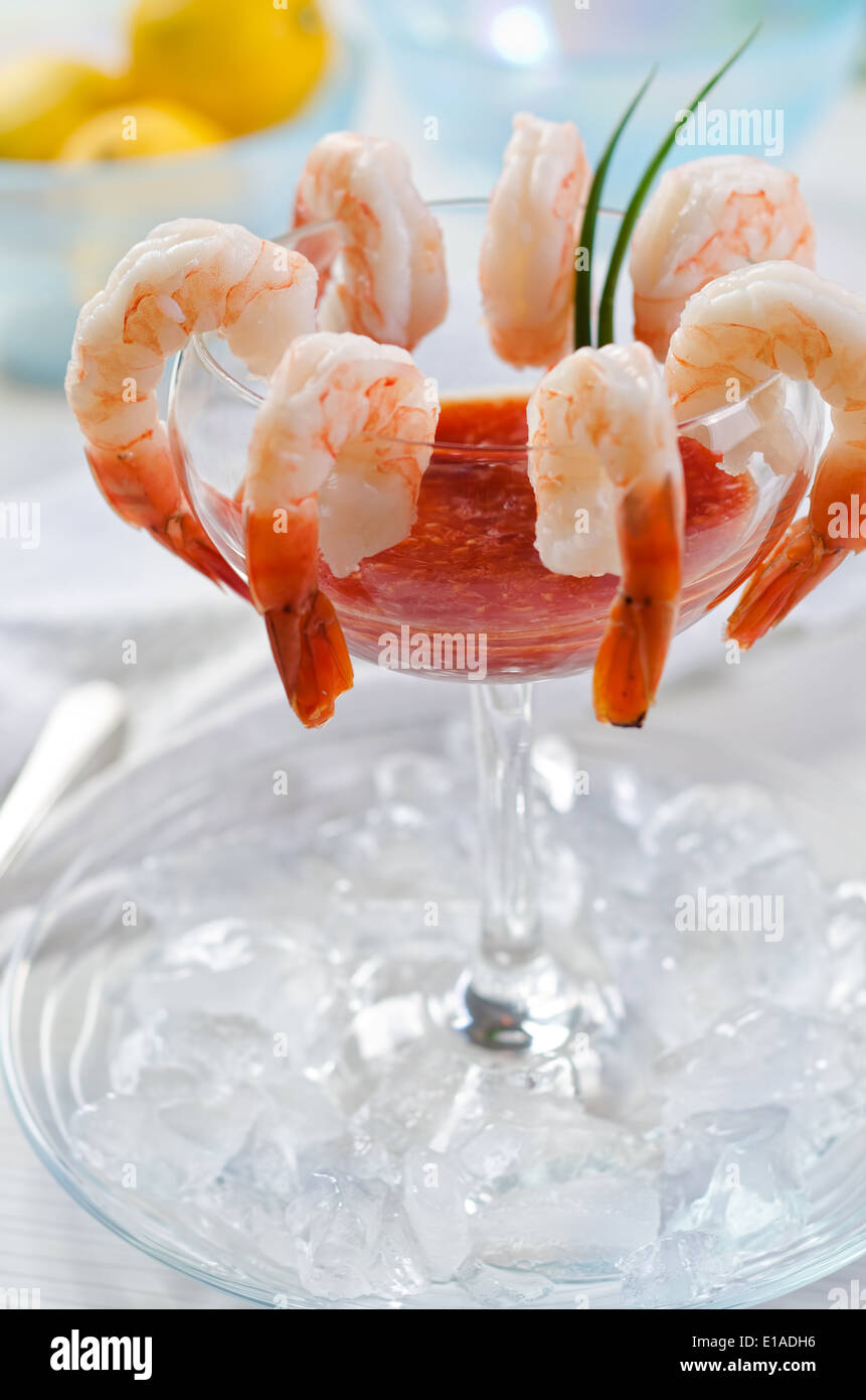 A traditional shrimp cocktail on ice with seafood sauce and lemon Stock