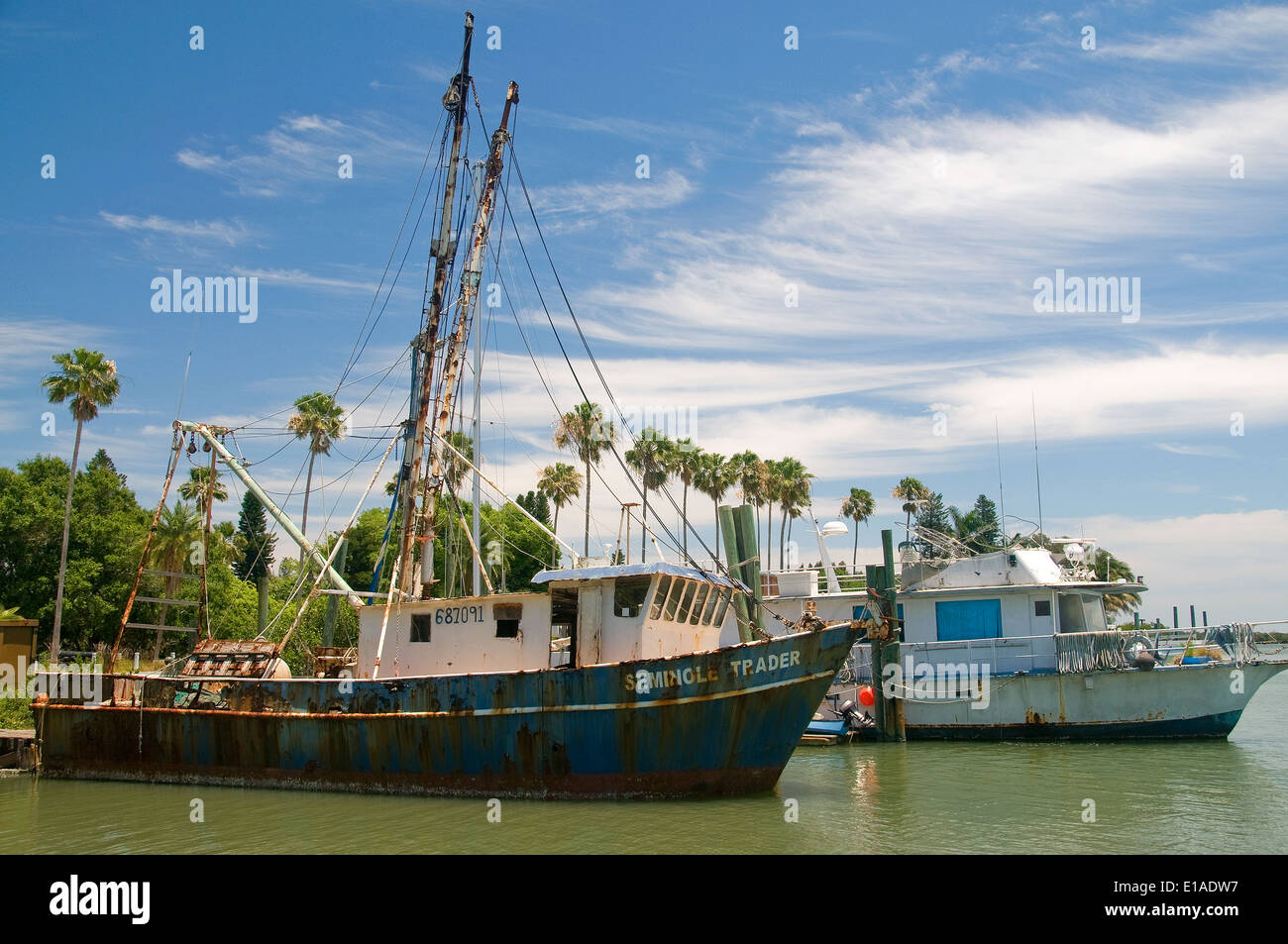 A couple of older commercial fishing boats are docked in the harbor at