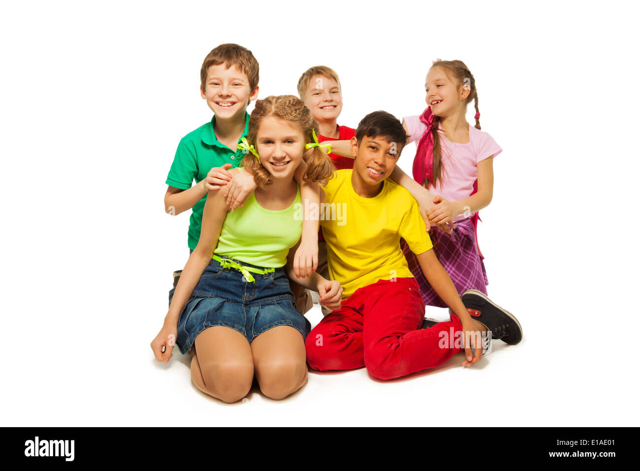 Laughing children sitting on the floor together Stock Photo - Alamy