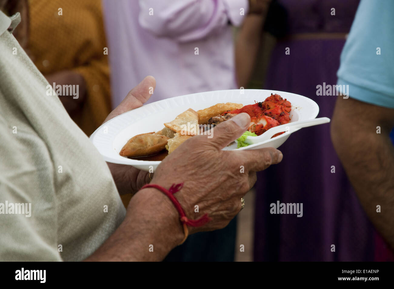 Man eating during an Indian pre-wedding vidhi celebration Stock Photo