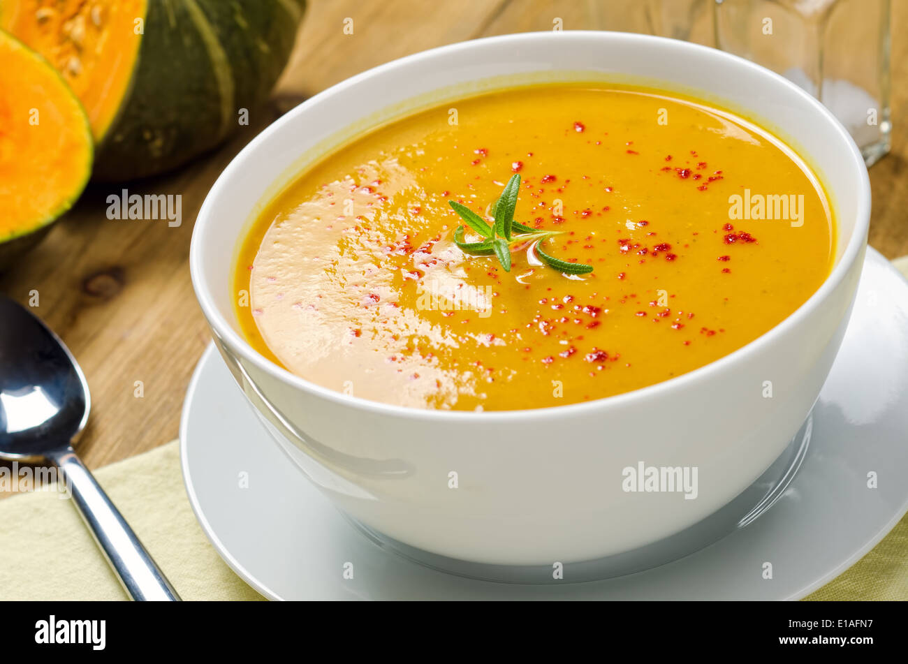 A hot bowl of creamy squash soup with rosemary and paprika. Stock Photo
