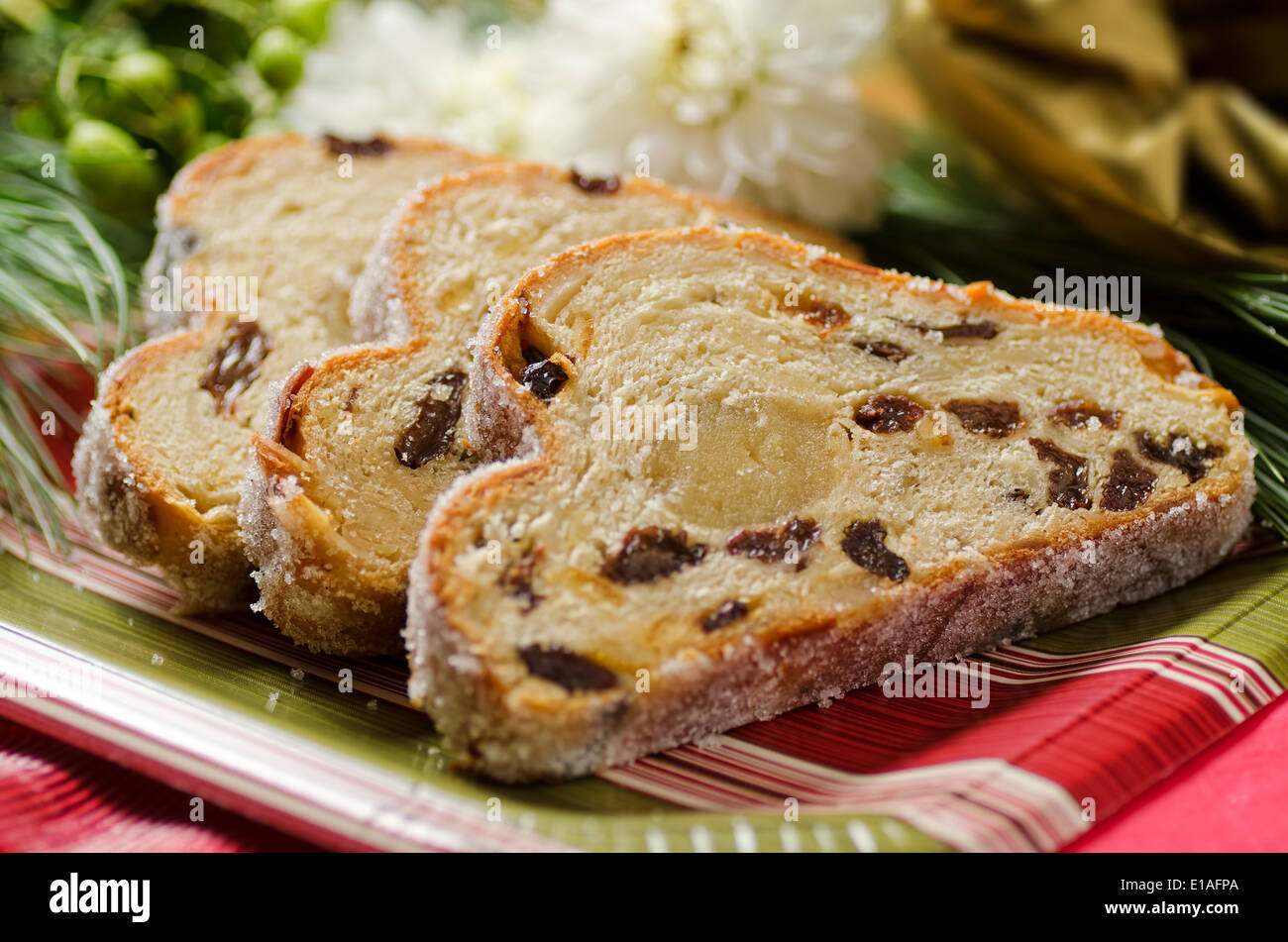 A traditional stollen fruit cake with raisins and marzipan center. Stock Photo