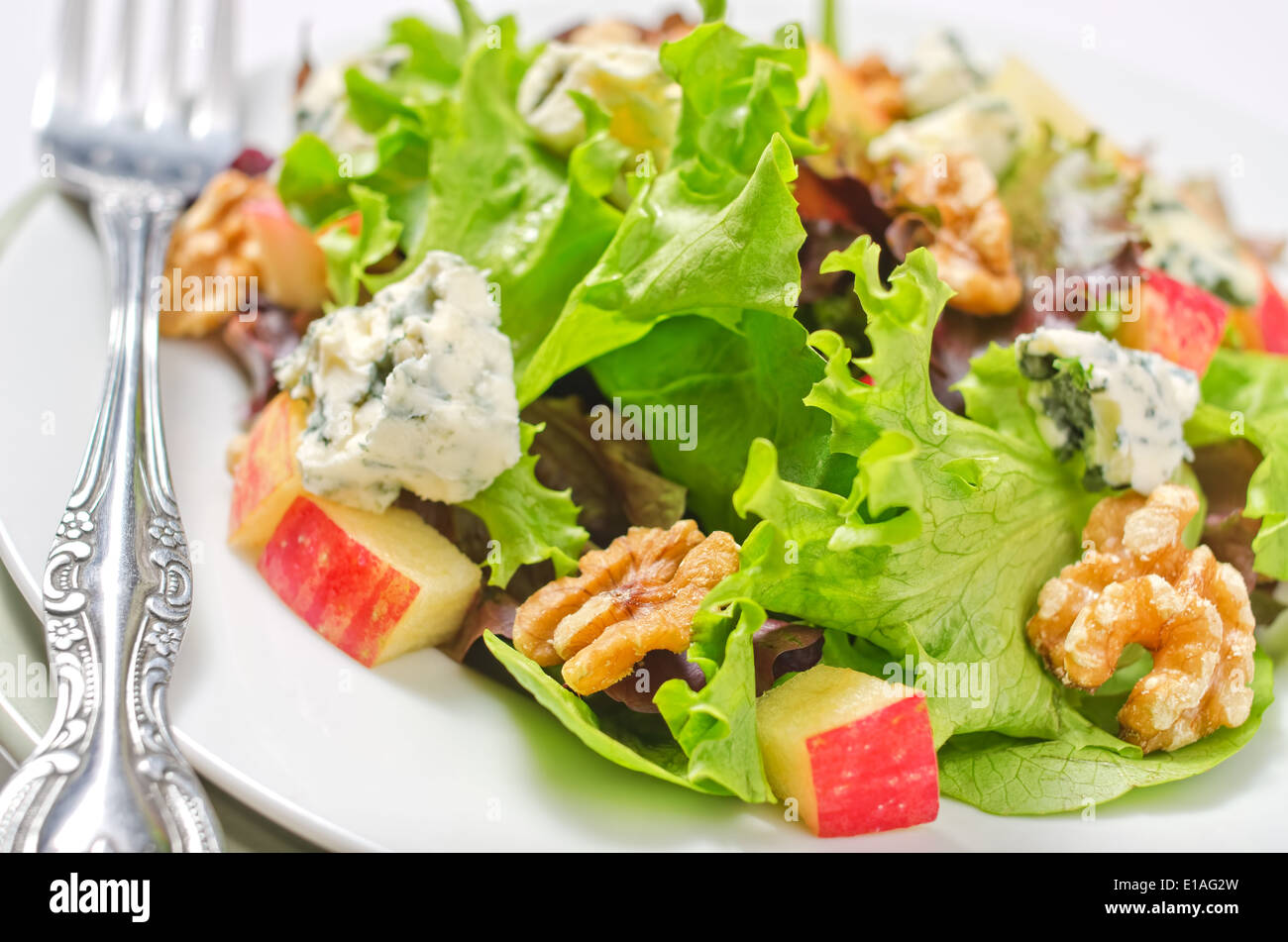 Waldorf salad with greens, apples, walnuts, and blue cheese. Stock Photo