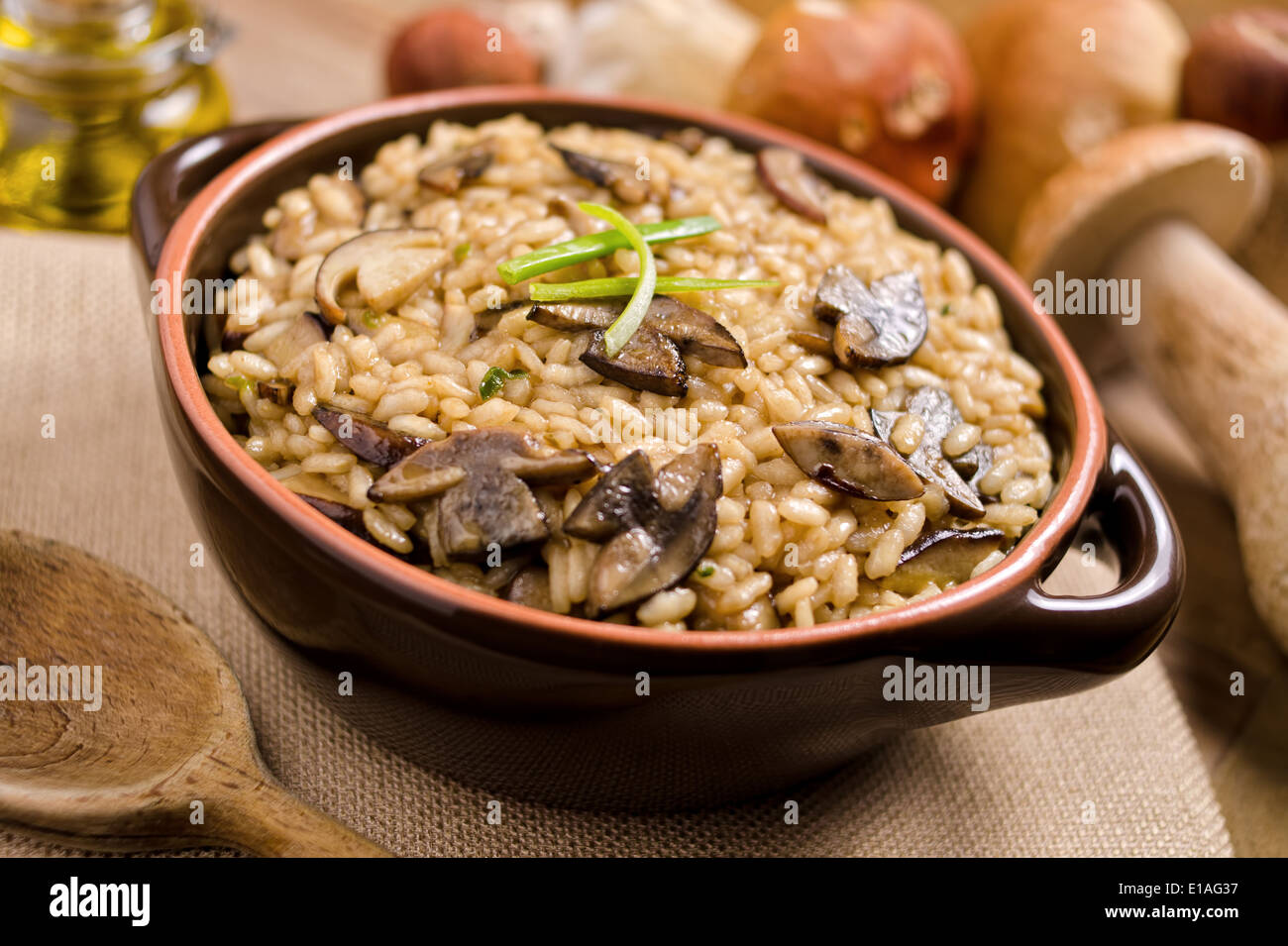 A bowl of wild mushroom risotto with arboreal rice and porcini mushrooms. Stock Photo