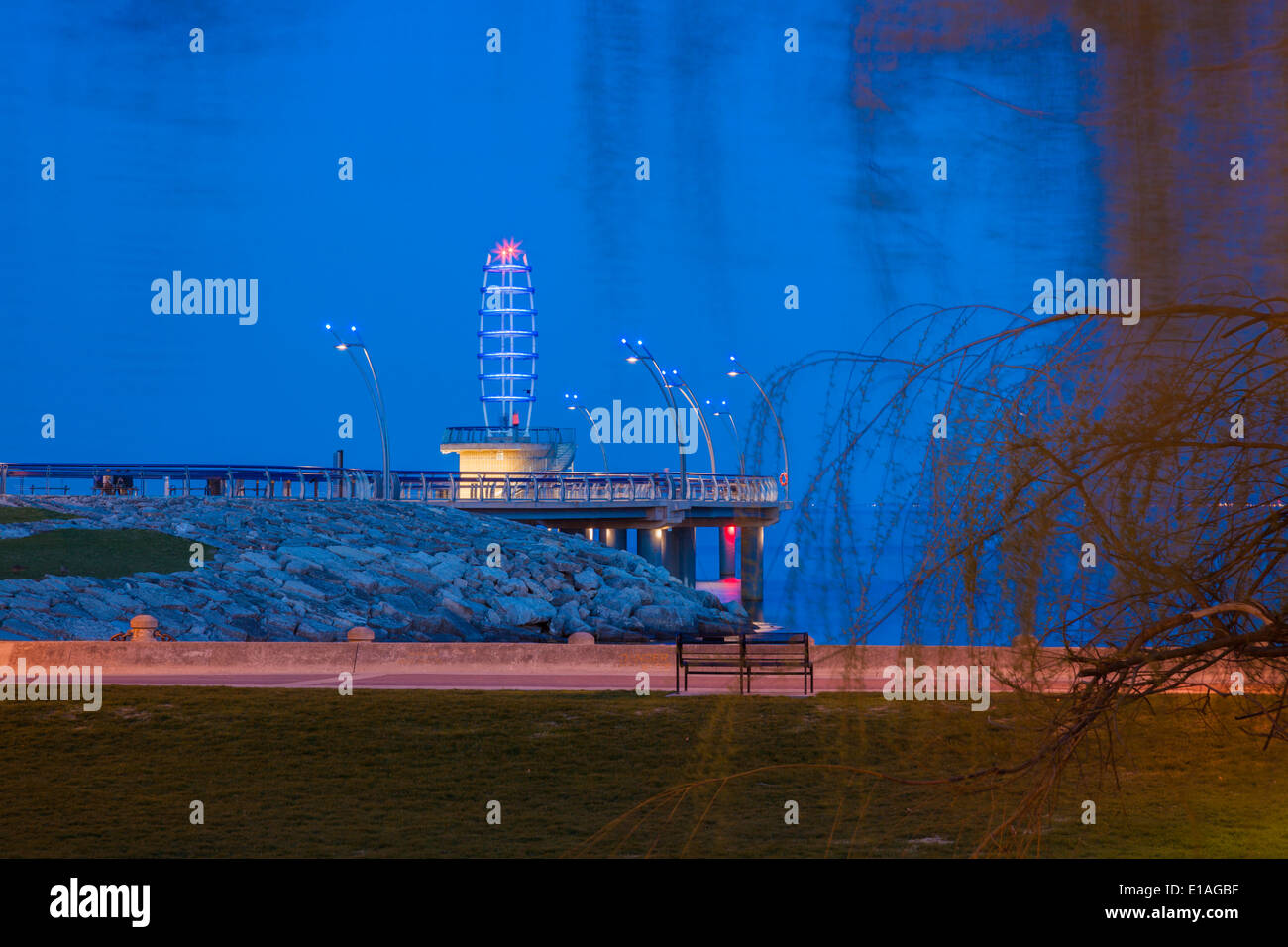 The waterfront and Brant Street Pier at Spencer Smith Park. Photographed through a willow tree in Burlington, Ontario, Canada. Stock Photo