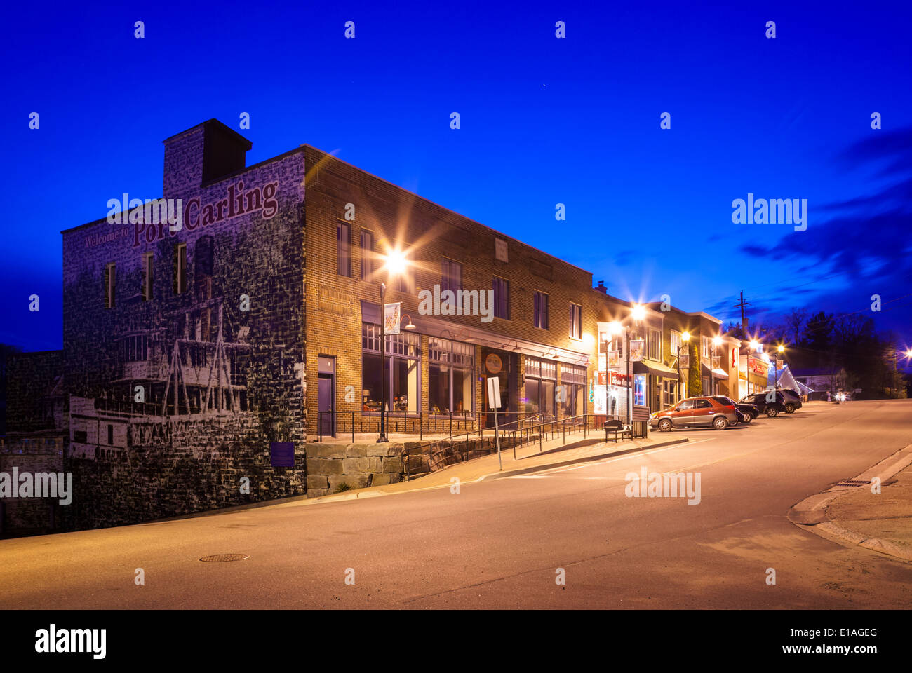 Commercial buildings with the to Port Carling' mural at dusk