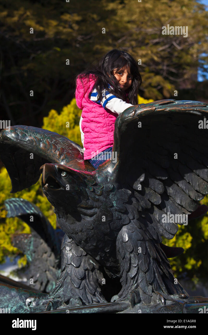 Young Mexican girl on EAGLE STATUE in the historical center of the city of QUERETARO - MEXICO Stock Photo