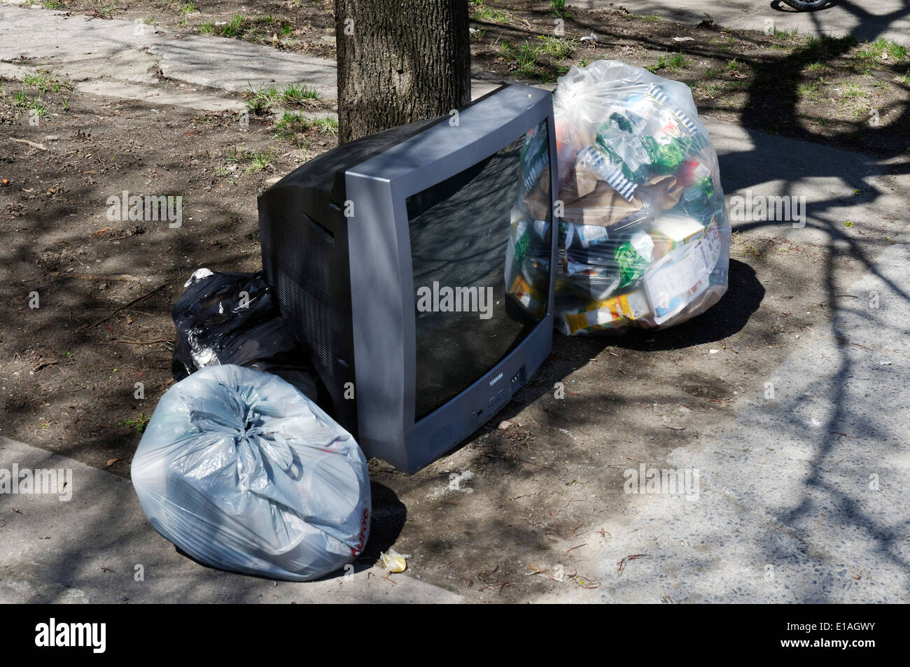 A TV thrown out with the garbage Stock Photo