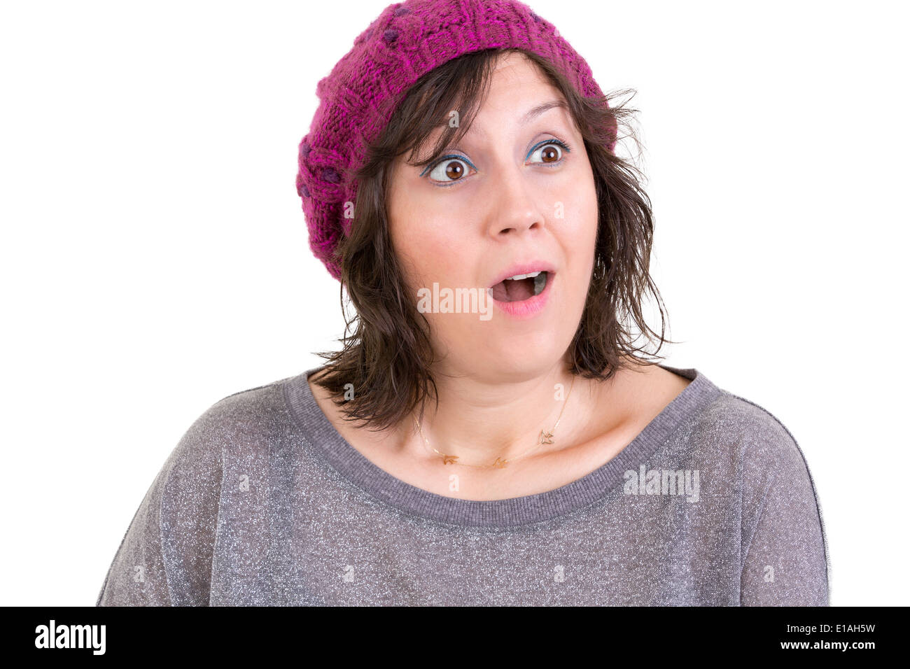 Woman with a look of wonder and amazement with wide eyes and an open mouth reacting in startled surprise isolated on white Stock Photo