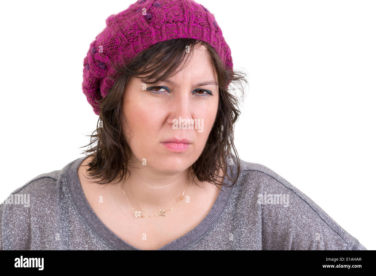 Woman frowning in disbelief with an assessing look peering at the camera with a calculating expression as she tries to fathom th Stock Photo
