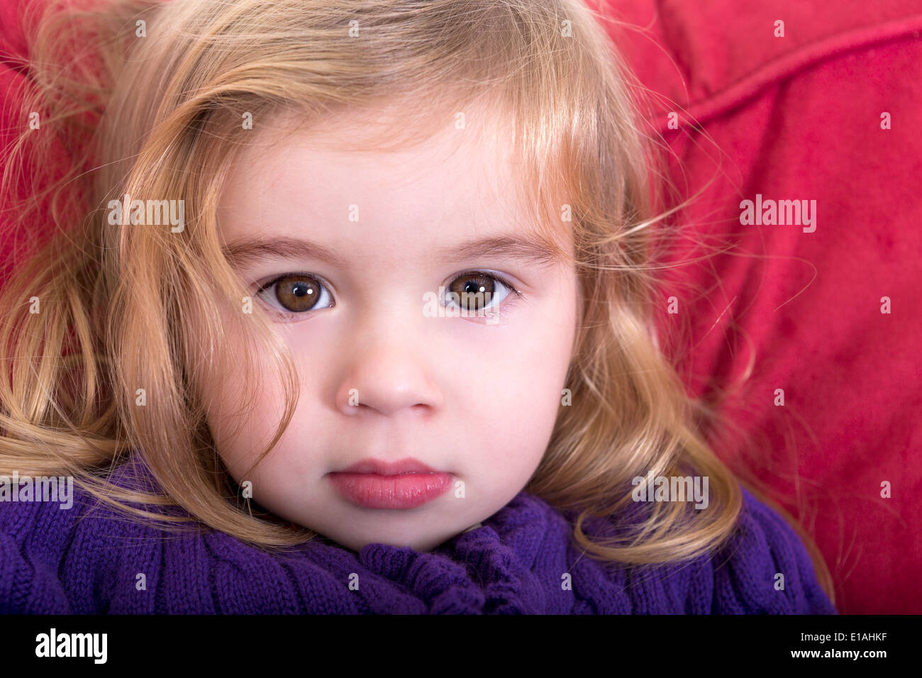 Close up facial portrait of a beautiful innocent young blond girl with