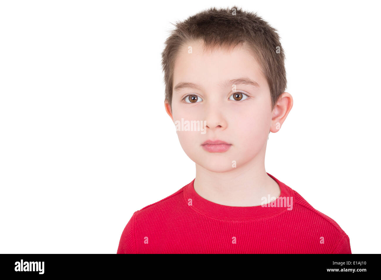 Sad wistful young boy with a solemn introvert expression staring off into the distance isolated on white with copy space Stock Photo