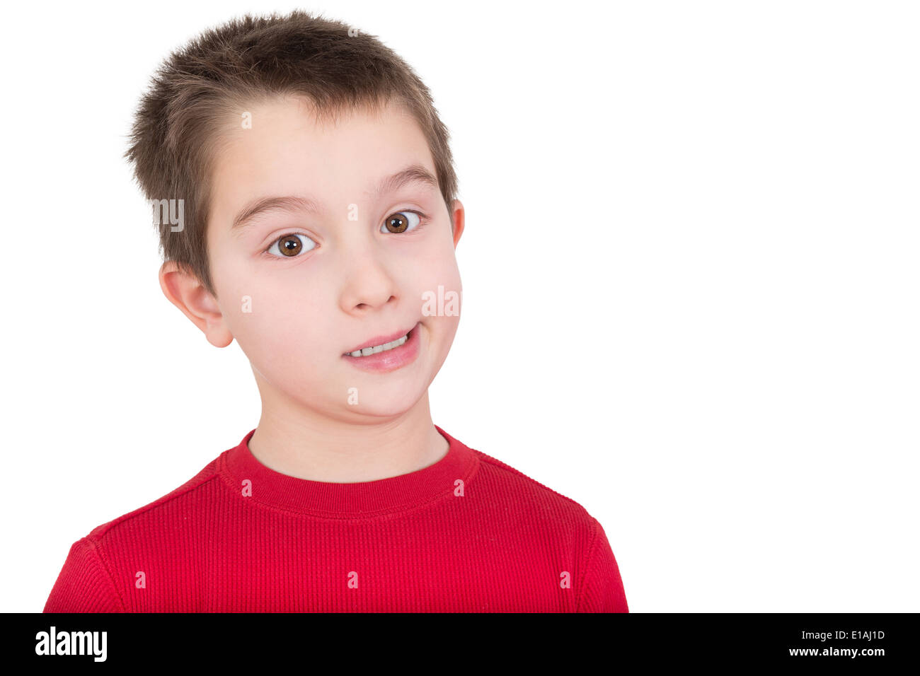 Skeptical young boy reacting in disbelief smiling ruefully and raising an eyebrow, isolated on white Stock Photo