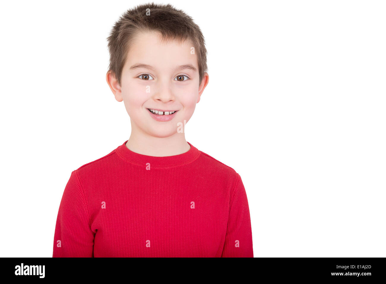 Young boy in a red t-shirt with a happy grin and alert expression, isolated on white Stock Photo