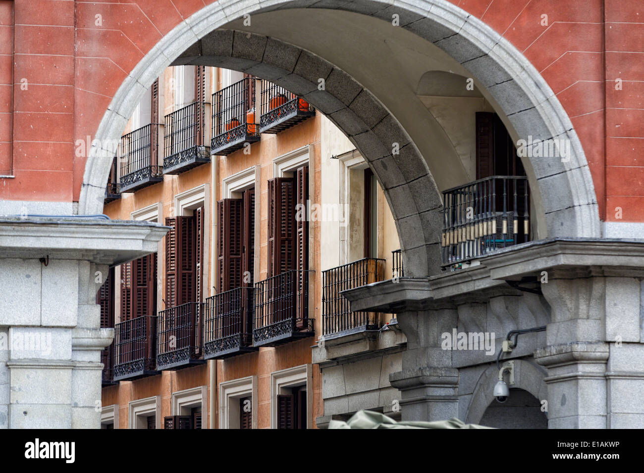 Balconies and Windows with Shutters Viewed through an Arch of a Building, Plaza Mayor, Madrid, Spain Stock Photo