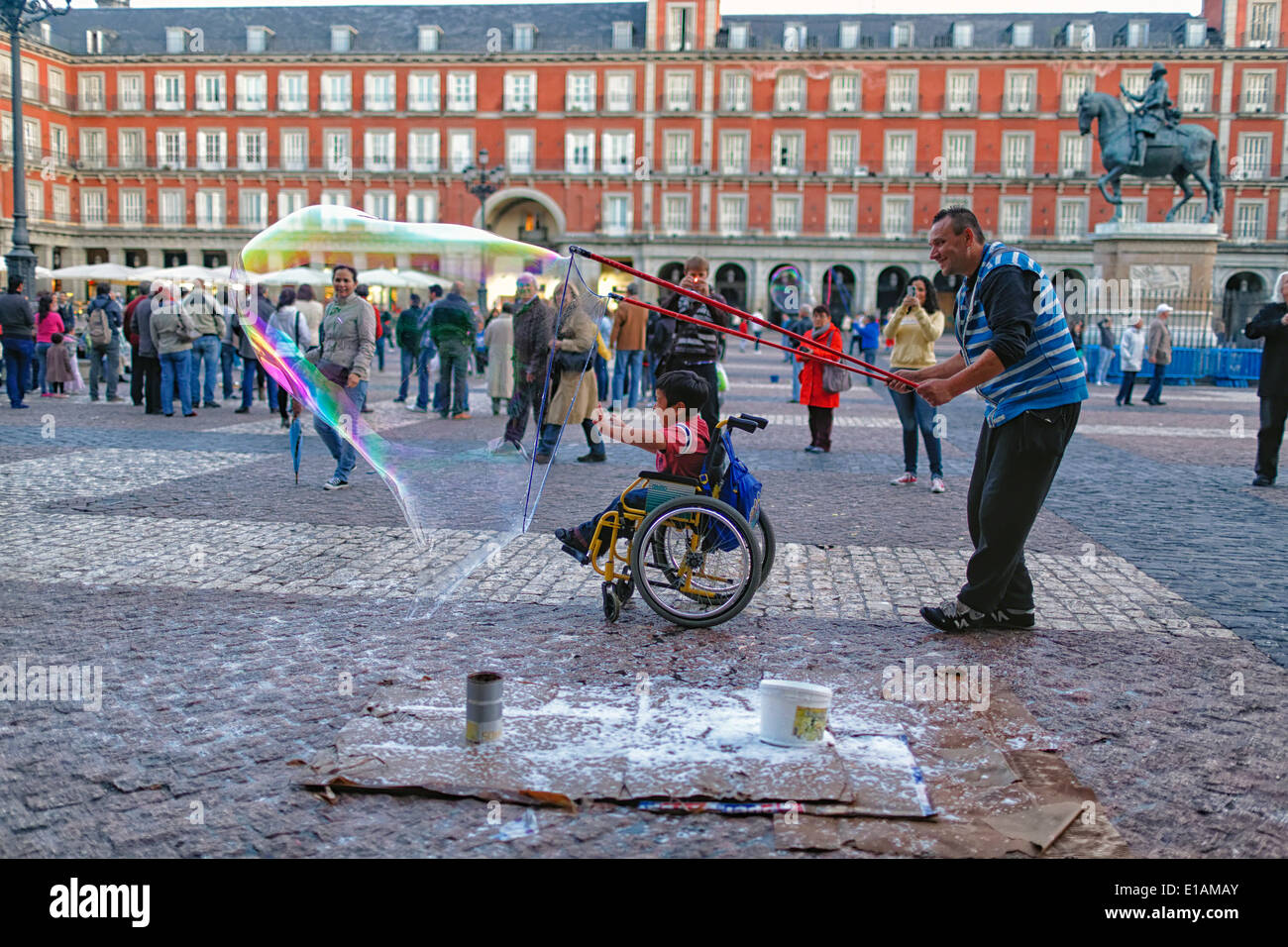 Soap Bubble Artist Enveloping Handicapped Child in a Wheelchair with