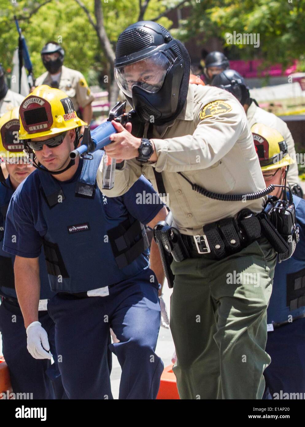 Los Angeles, USA. 28th May, 2014. Members of Special Enforcement Bureau cover the rescue team entering Los Angeles County Hall of Administration during a training exercise involving a simulated shooting in downtown Los Angeles, the United States, on May 28, 2014. The Los Angeles County Sheriff's Department held a large-scale training exercise involving a simulated shooting taking place at a Board of Supervisors meeting here Wednesday. Credit:  Zhao Hanrong/Xinhua/Alamy Live News Stock Photo