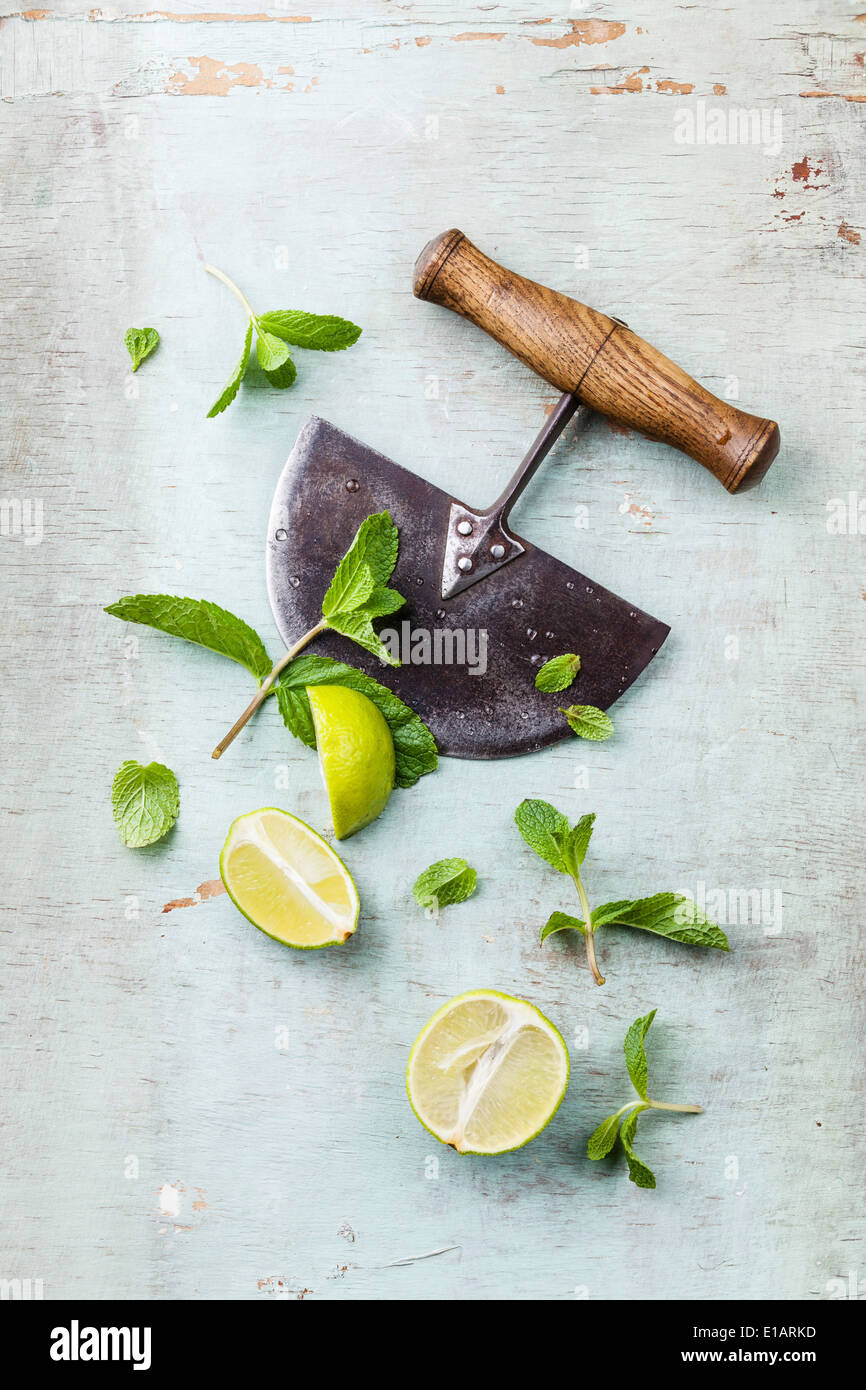 Ingredients for making mojitos mint leaves and lime on blue background Stock Photo