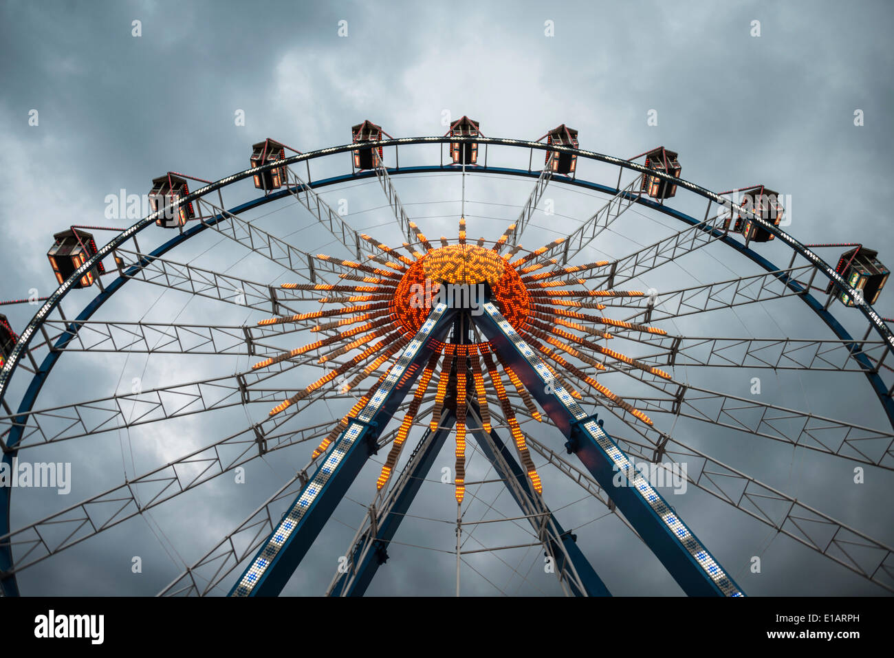 Ferris wheel against dark clouds, Munich Spring Festival, Theresienwiese, Munich, Bavaria, Germany Stock Photo