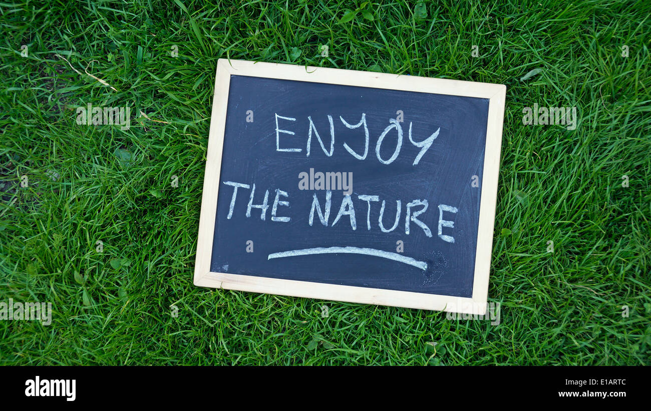 Enjoy the nature written on a chalkboard in a park Stock Photo - Alamy