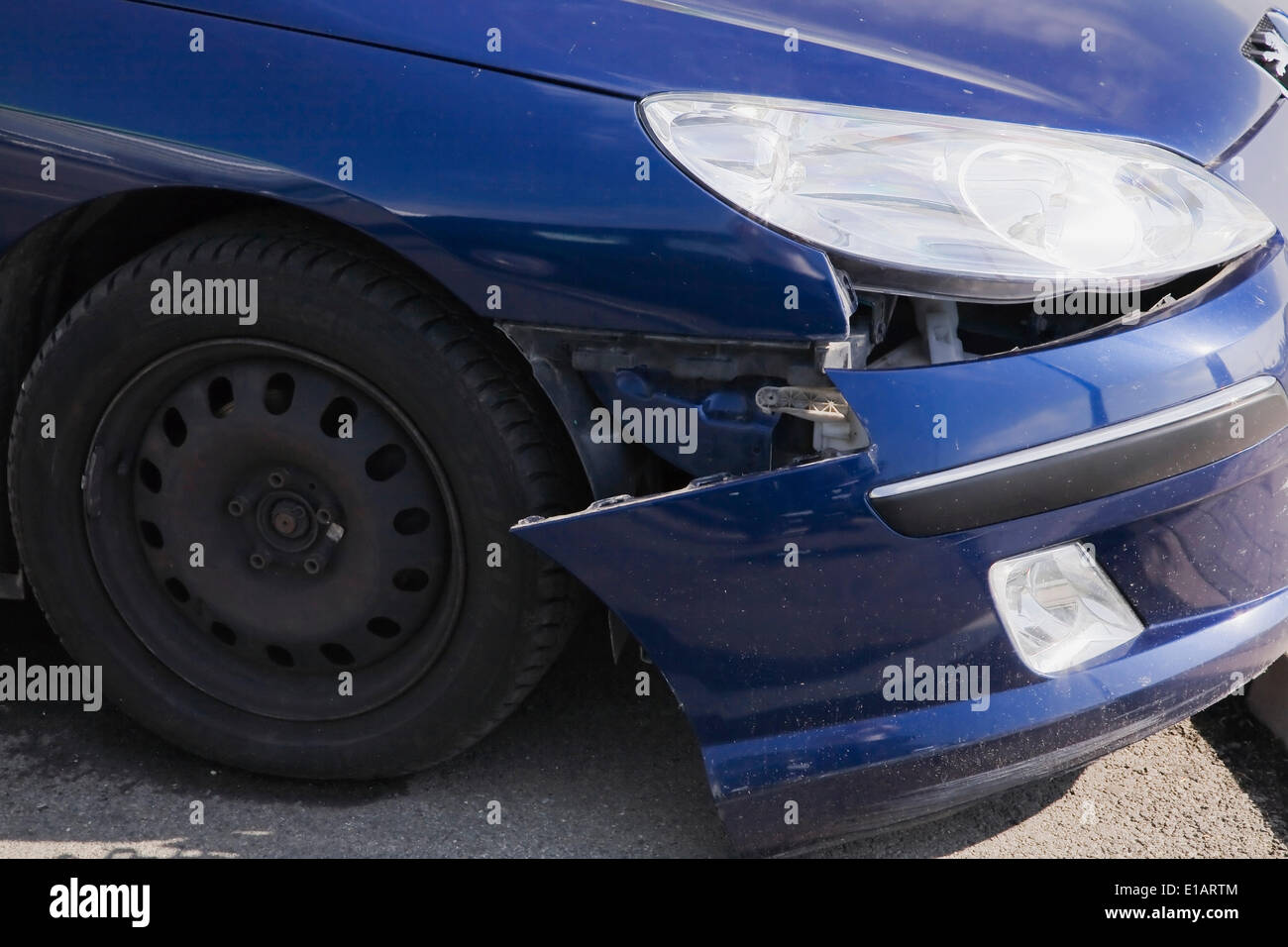 Blue compact car with an accident-damaged front bumper, Hungary Stock Photo