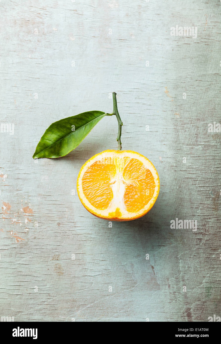 Ripe orange with leaf on textured background Stock Photo