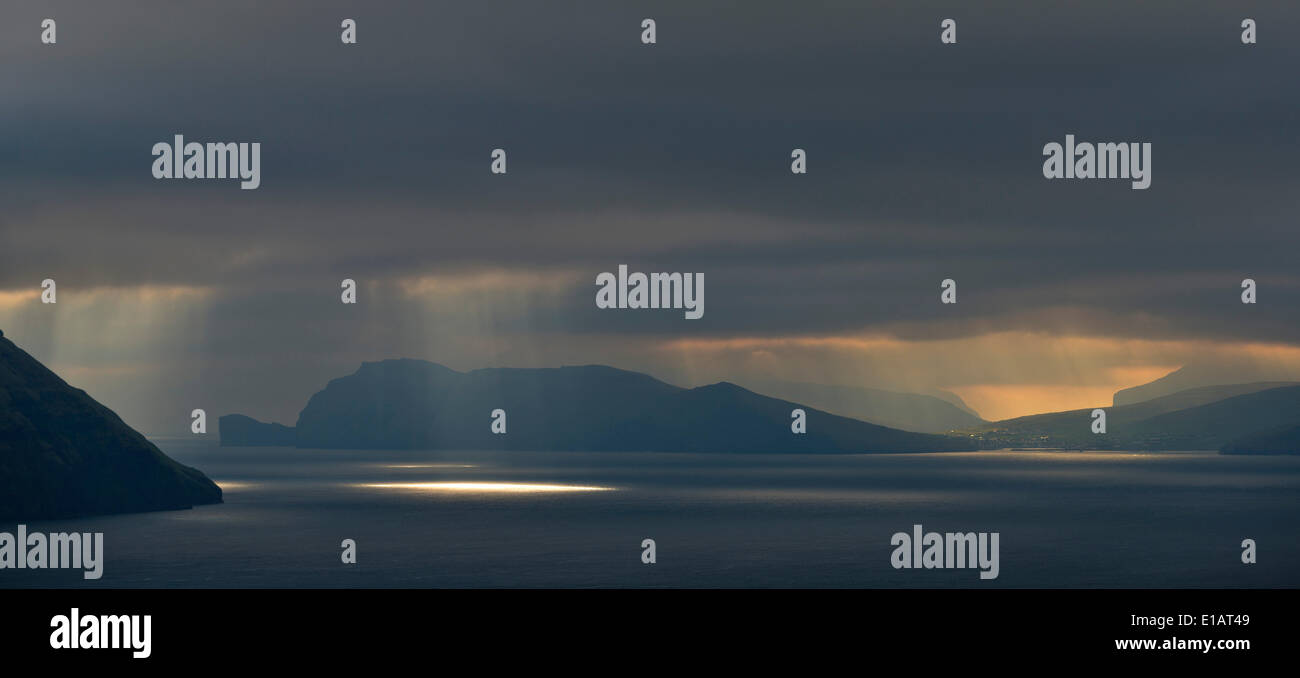 Mood light with low-hanging clouds, Koltur and Vagar islands, Faroe Islands, Denmark Stock Photo