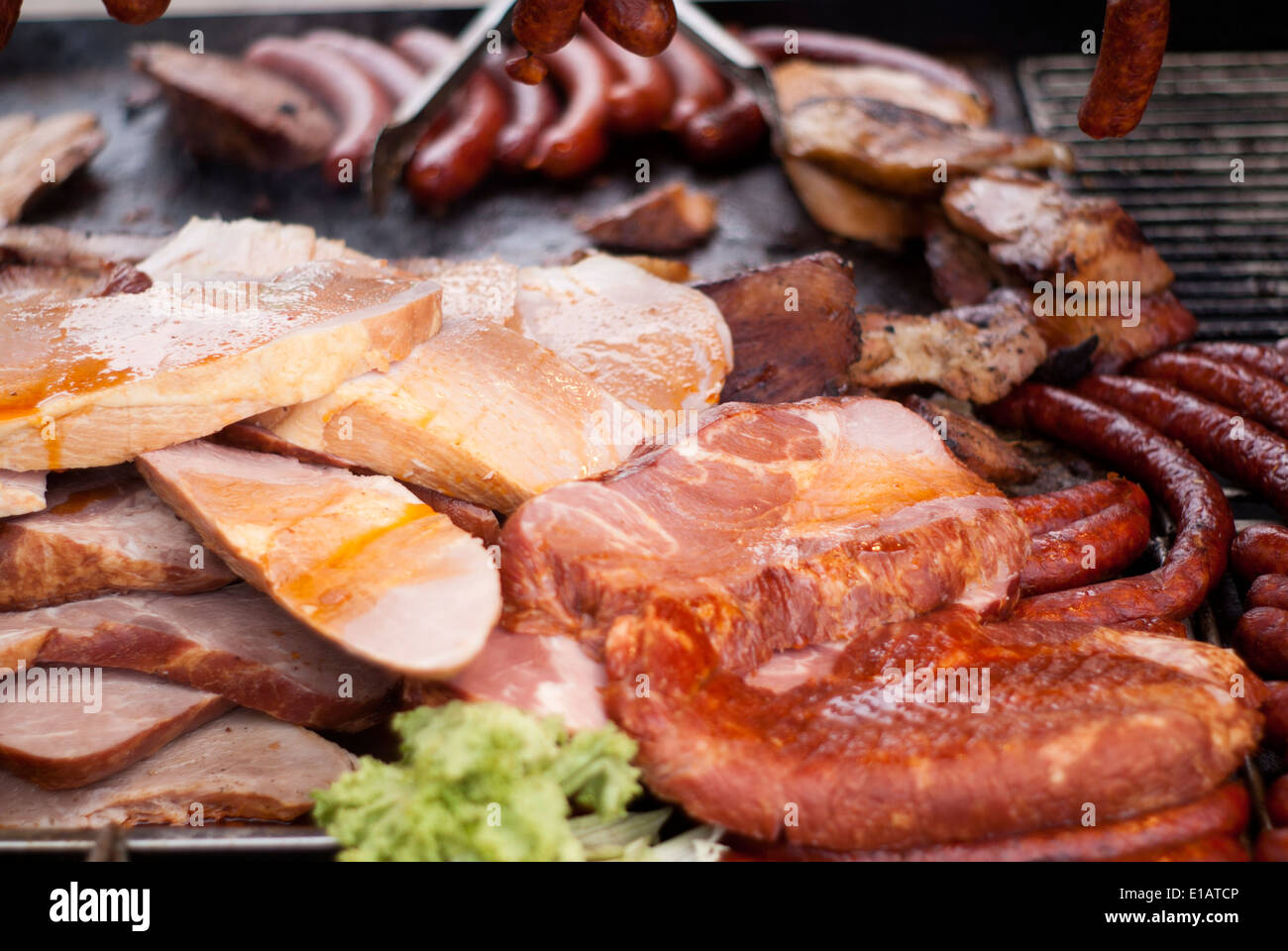 Meat like bacon, beef, speck, steak and wurst on a grill Stock Photo