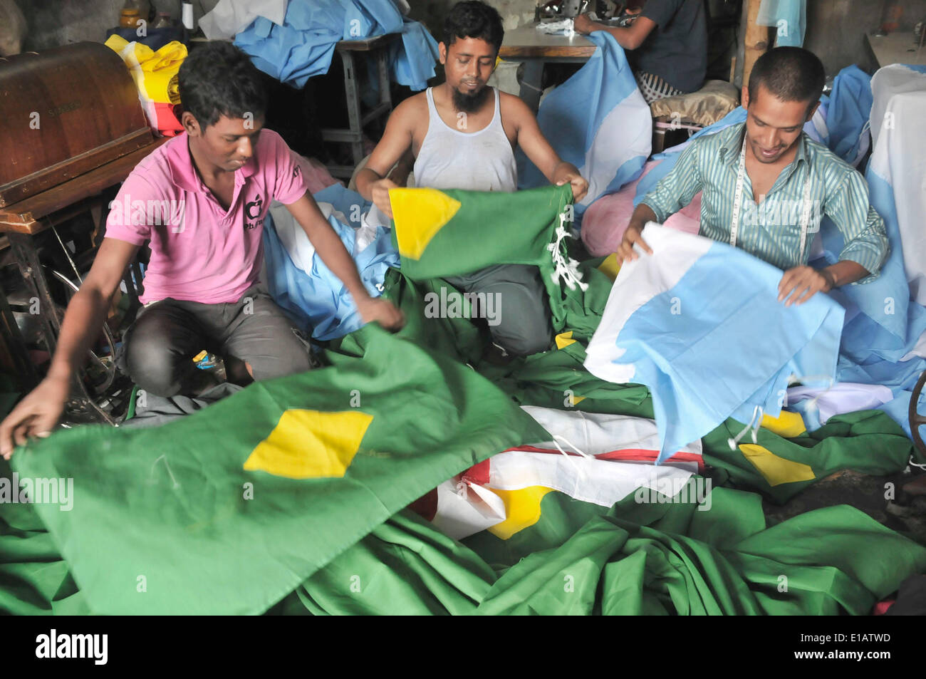 Dhaka, May 29. 12th June, 2014. Tailors are busy making flags ahead of the upcoming 2014 FIFA World Cup in Dhaka, Bangladesh, May 29, 2014. The 2014 FIFA World Cup International Football tournament will kick off in Brazil on June 12, 2014. © Shariful Islam/Xinhua/Alamy Live News Stock Photo