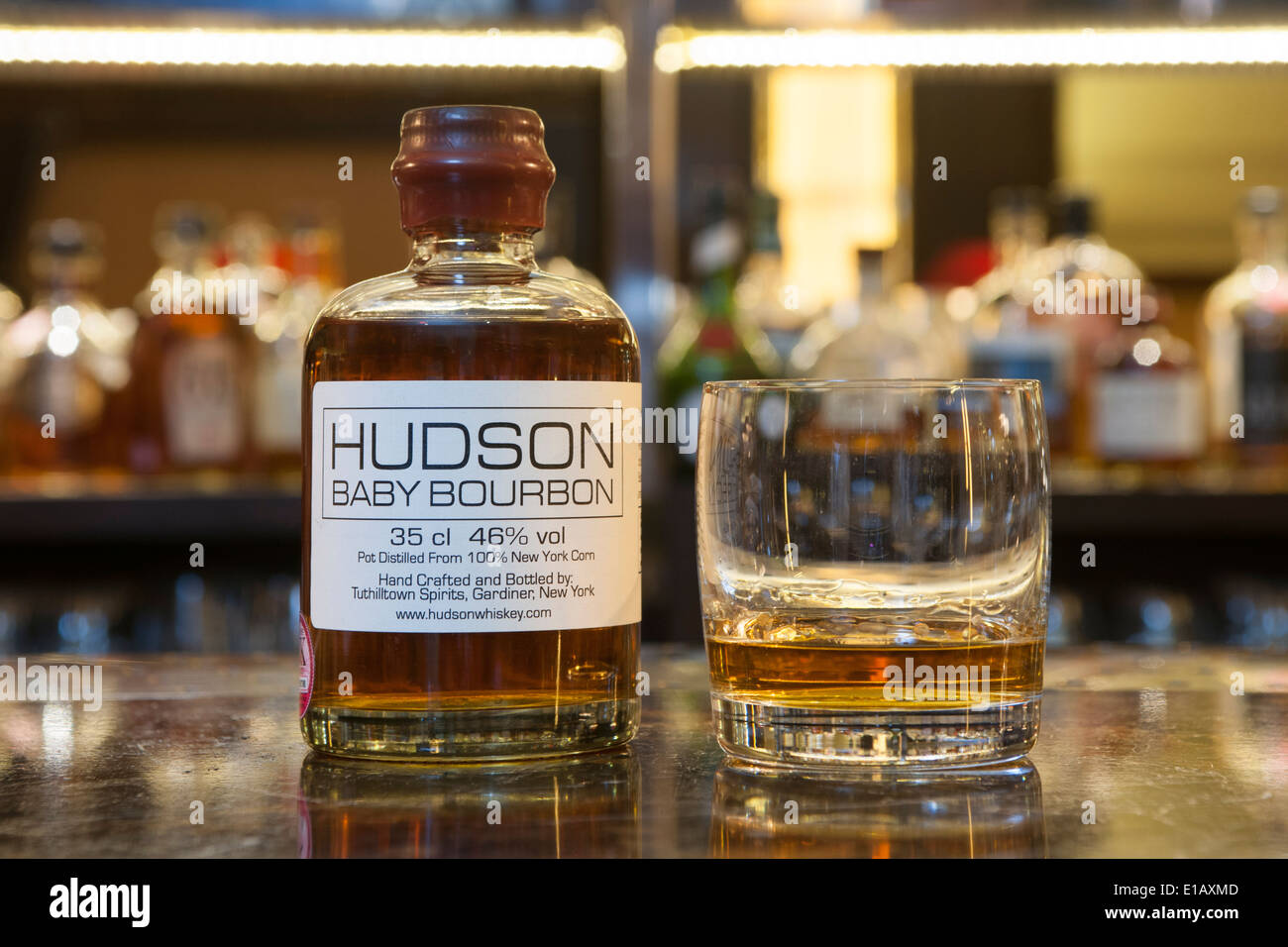 bottle of Hudson bourbon on a bar with a glass Stock Photo