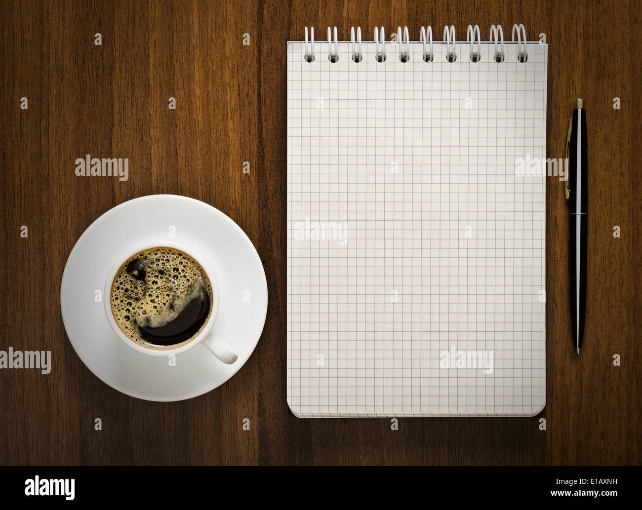 notebook with pen and cup of coffee on your desktop Stock Photo