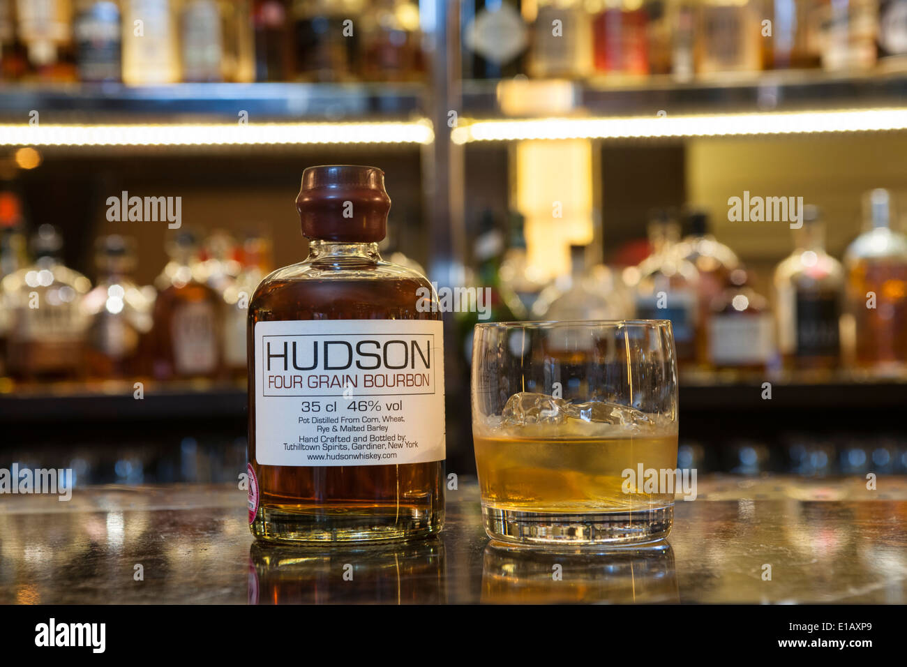 bottle of Hudson bourbon on a bar with a glass Stock Photo