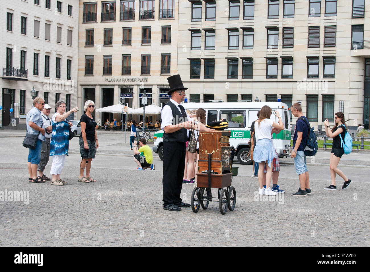 A barrel organ player at the Brandenburg Gate Germany Stock Photo