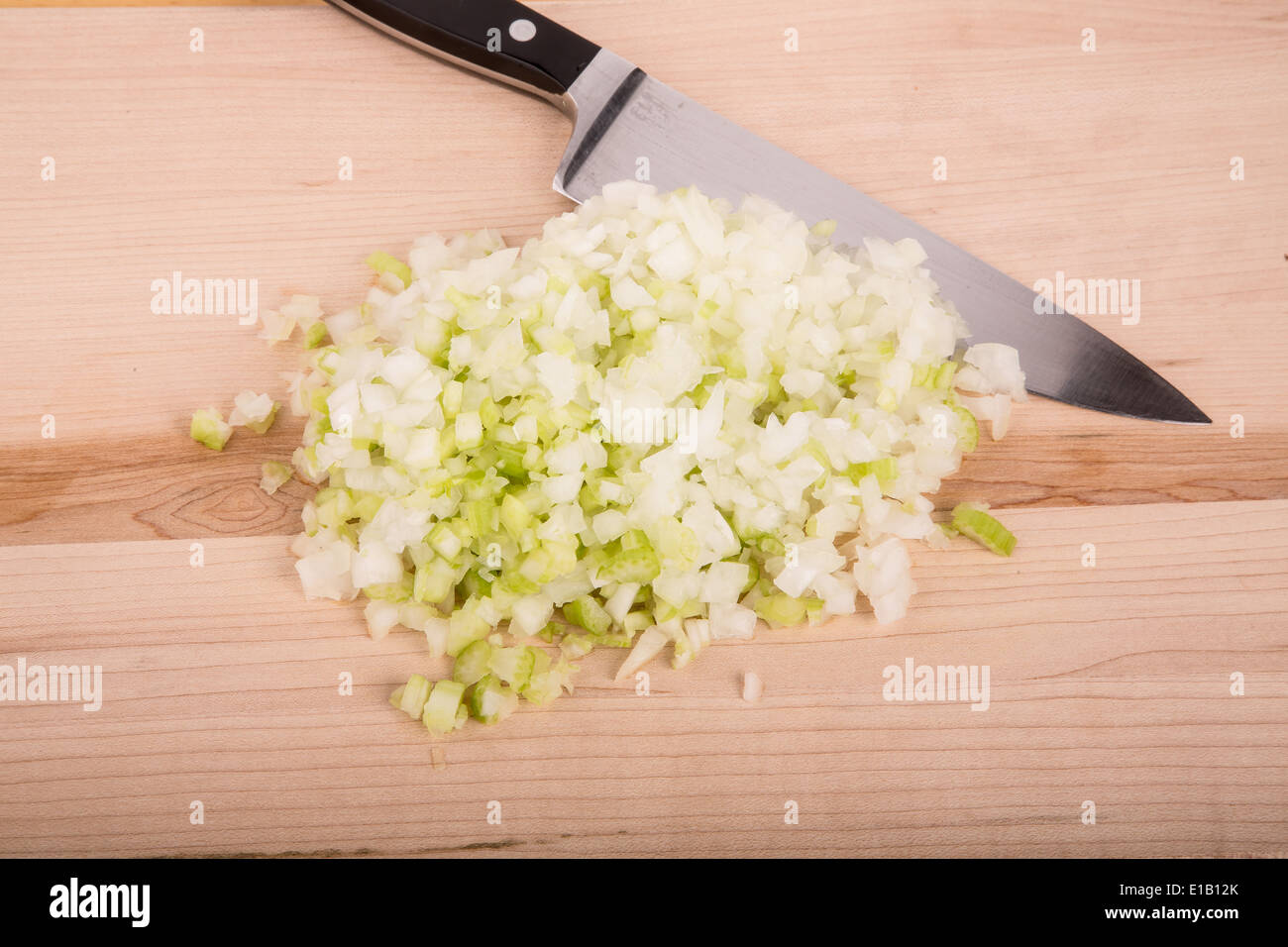 Chopping fresh onions and celery on a wood cutting board Stock Photo Alamy