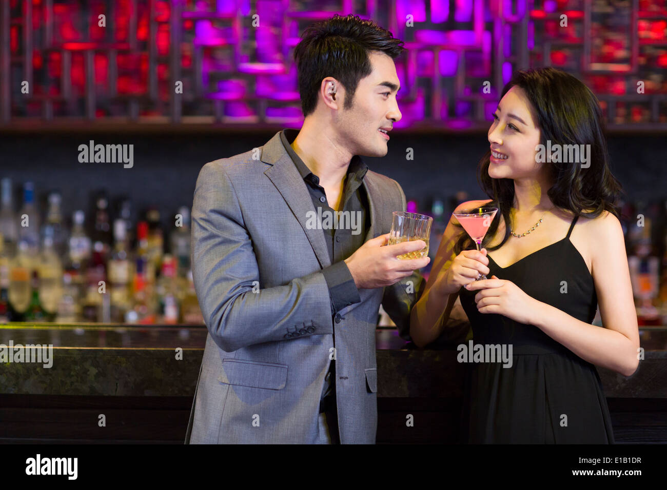 Young man and woman flirting at bar Stock Photo - Alamy, image size:1300x956