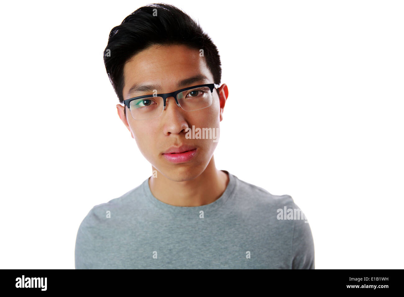 Portrait of a young pensive asian man over white background Stock Photo