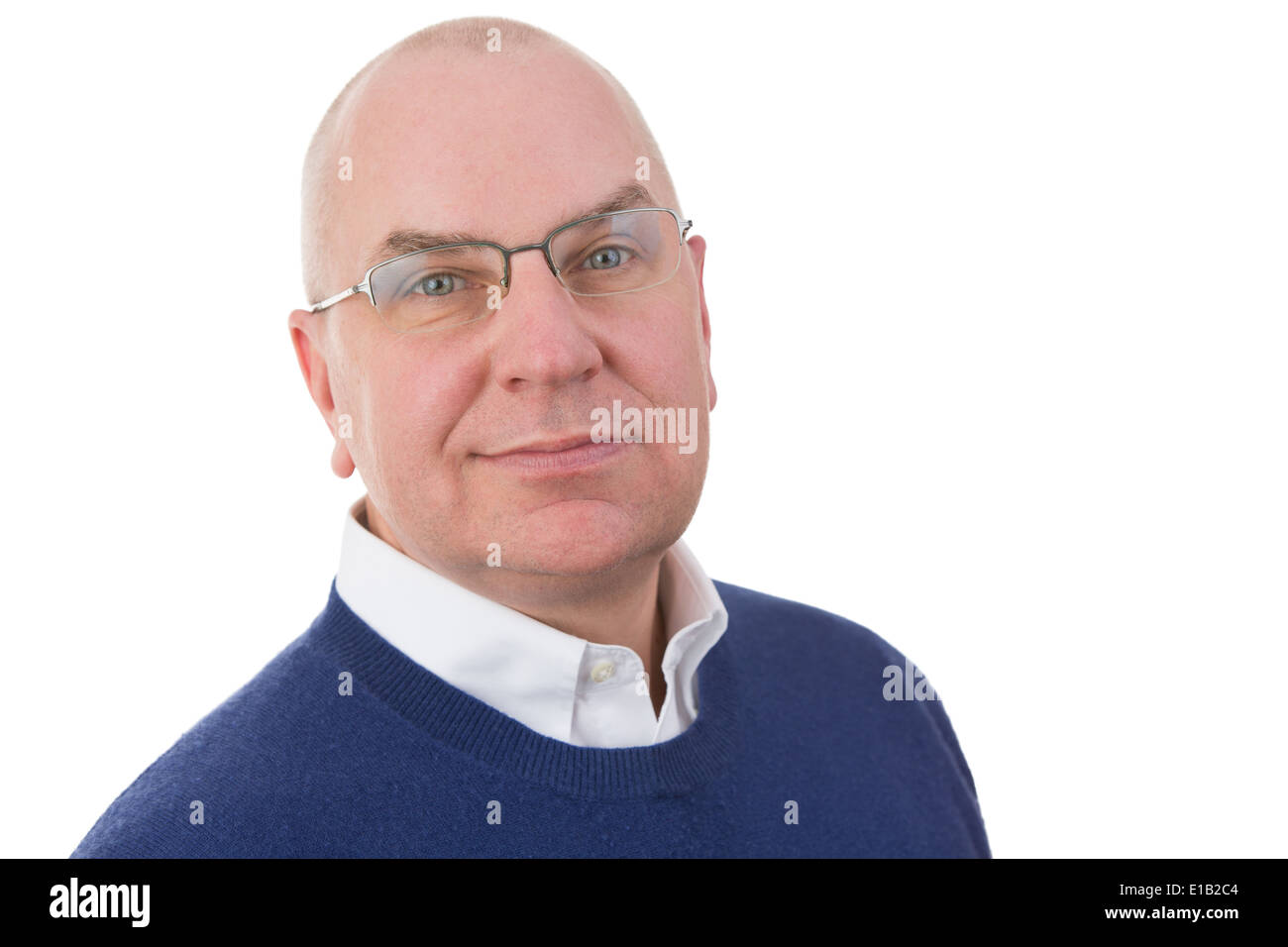 Observant middle-aged businessman looking at the camera with a serious sincere expression and a half smile, head and shoulders p Stock Photo