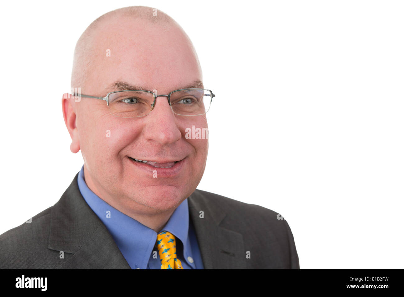 Smiling complacent businessman pleased with his achievements looking to the side with a self-satisfied smile,head and shoulders Stock Photo