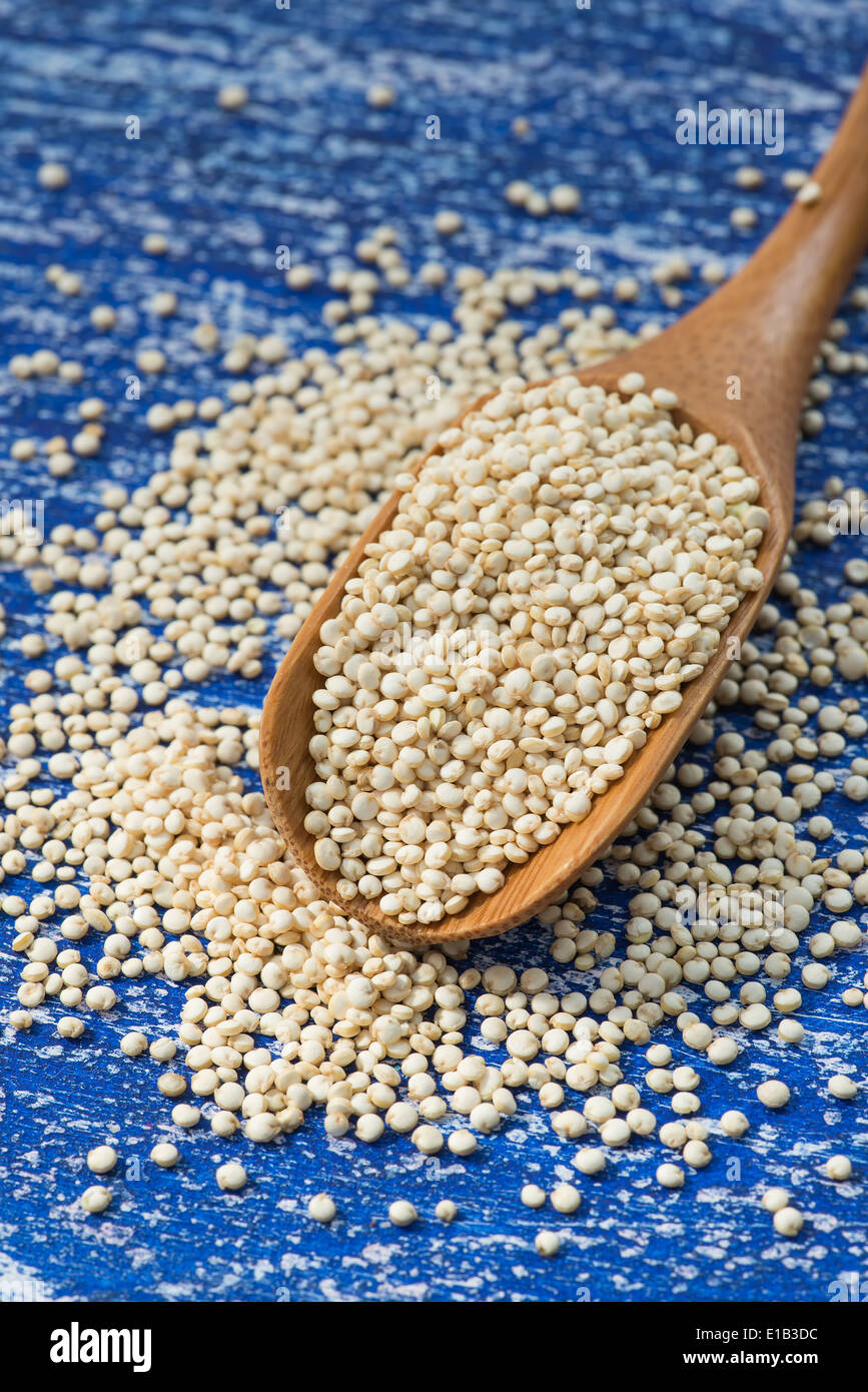Raw white quinoa in spoon, selective focus Stock Photo