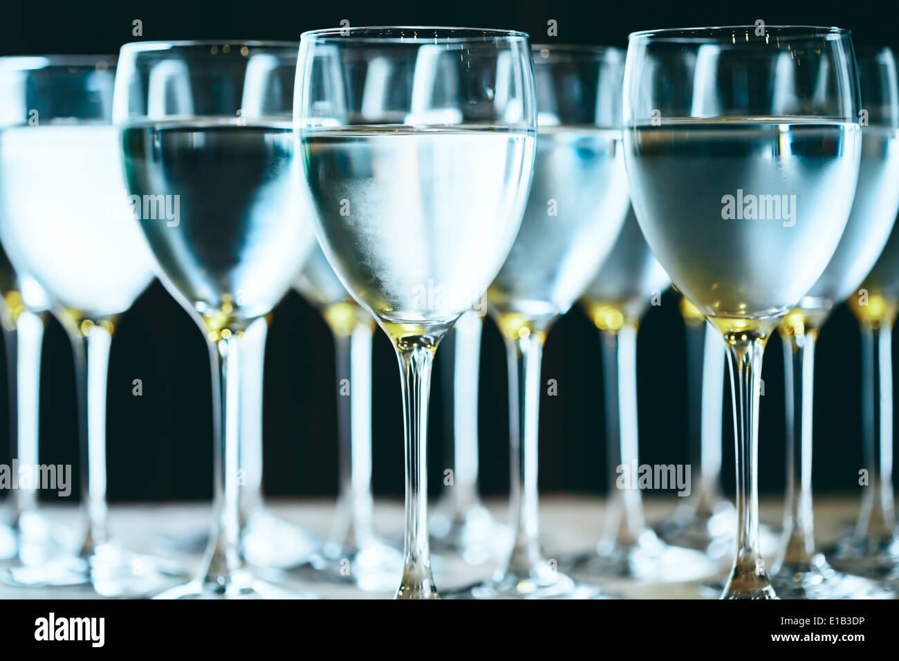 Row of water glasses. Pure drinking water. Selective focus. Stock Photo