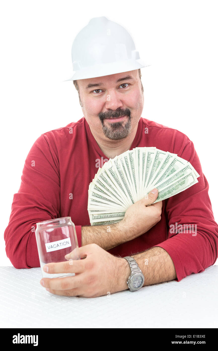 Construction worker with a hard-hat holding vacations money Stock Photo