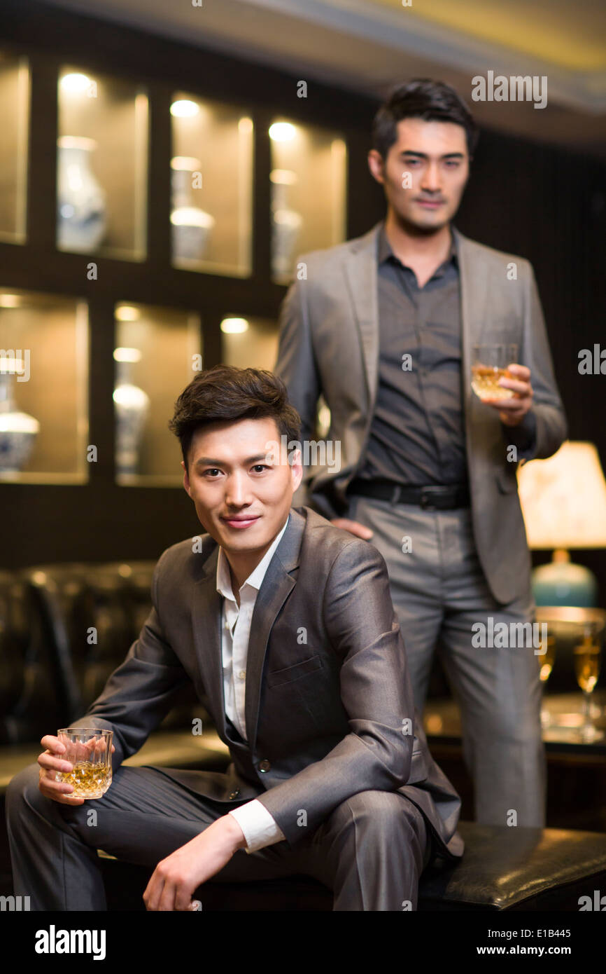 Business partners drinking alcohol in luxury club Stock Photo